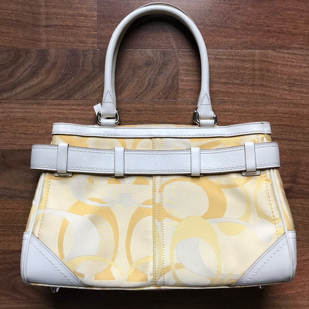 Women’s yellow Coach brand handbag/purse.